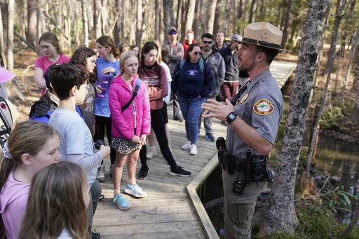 Park ranger Jesse Anderson speaks to visitors during a weekly carnivorous plant hike Saturday, March 22, 2025, in Carolina Beach, N.C. (AP Photo/Erik Verduzco)