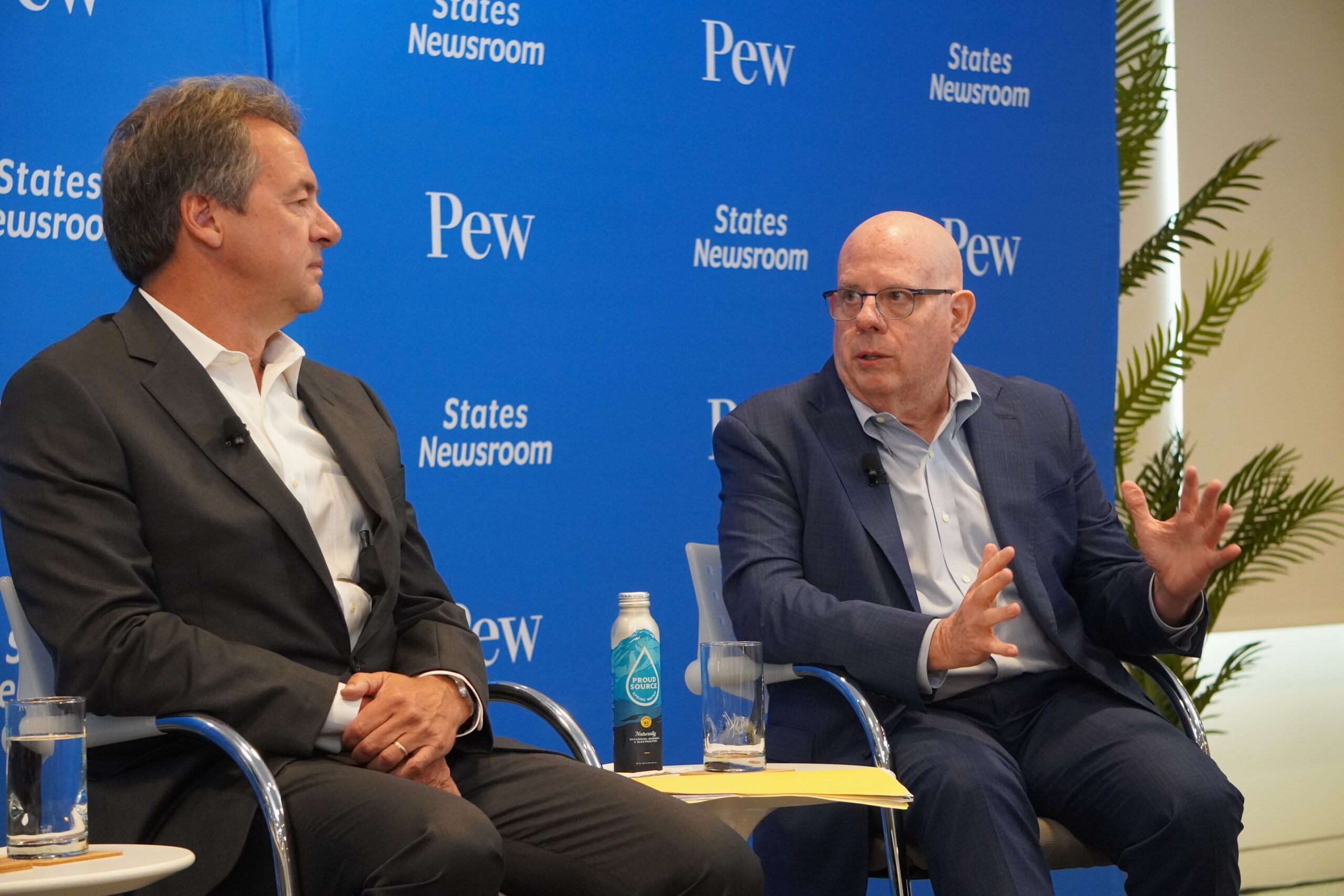 In a conversation with former Gov. Steve Bullock, D-Montana, (left), former Gov. Larry Hogan, R-Maryland, (right) says extreme gerrymandering and political primaries that select the more extreme sides of each political party contribute to a sense of gridlock and polarization. (Photos by Danielle Brown/Maryland Matters)