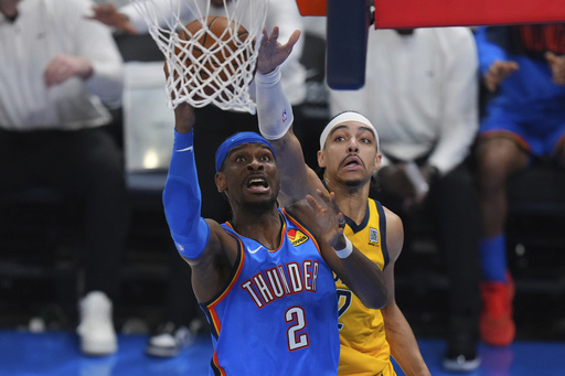 Oklahoma City Thunder guard Shai Gilgeous-Alexander, left, shoots against Indiana Pacers guard Andrew Nembhard during the second half of Game 7 of the NBA Finals basketball series Sunday, June 22, 2025, in Oklahoma City. (AP Photo/Nate Billings)