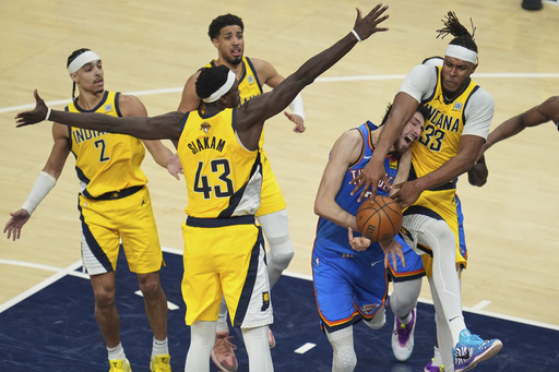 Oklahoma City Thunder forward Chet Holmgren (7) is fouled by Indiana Pacers center Myles Turner (33) during the second half of Game 3 of the NBA Finals basketball series, Wednesday, June 11, 2025, in Indianapolis. (AP Photo/Michael Conroy)