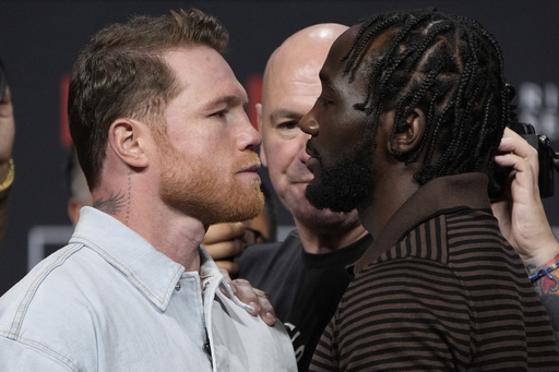 Canelo Alvarez, left, and Terence Crawford face off during a news conference for their upcoming boxing match Friday, June 27, 2025, in Las Vegas. (AP Photo/John Locher)