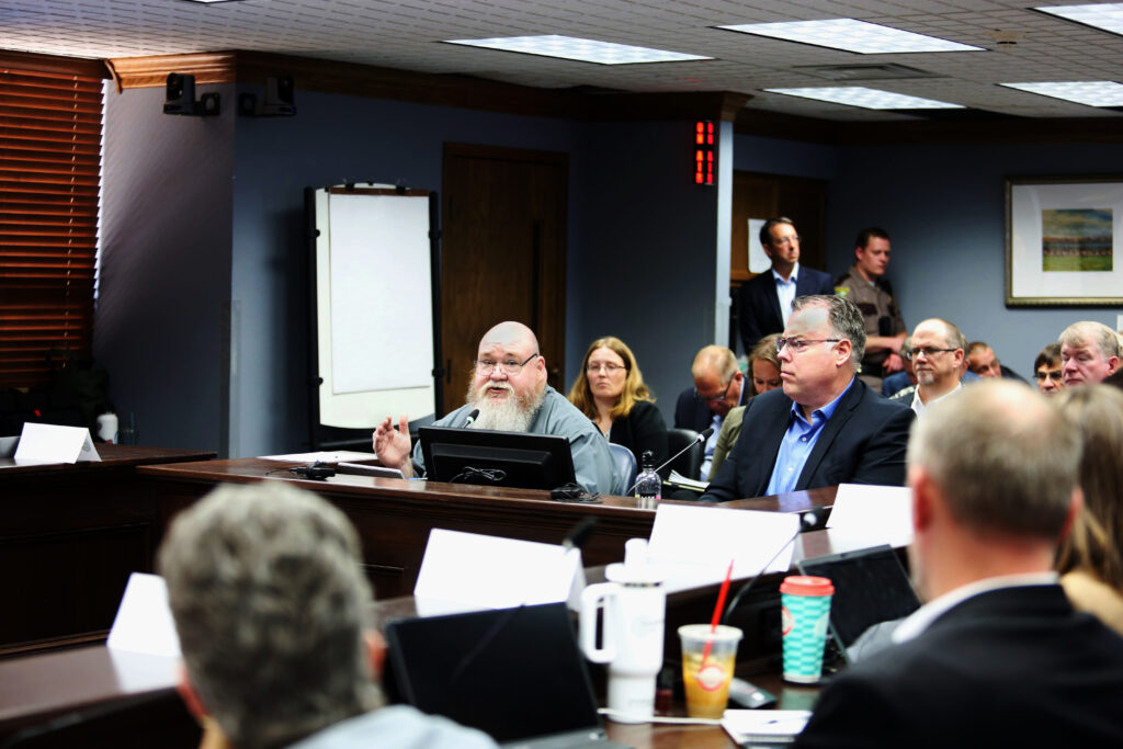  Mike Quinn and Mike Conder of Arrington Watkins consultants in Phoenix, speak to members of the Project Prison Reset work group on June 3, 2025 in Pierre, SD. (Makenzie Huber/South Dakota Searchlight)