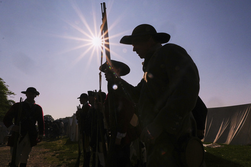 Colonial soldiers prepare to face the British during a reenactment in celebration of the 250th anniversary of the Battle of Bunker Hill, Saturday, June 21, 2025, in Gloucester, Mass. (AP Photo/Charles Krupa)