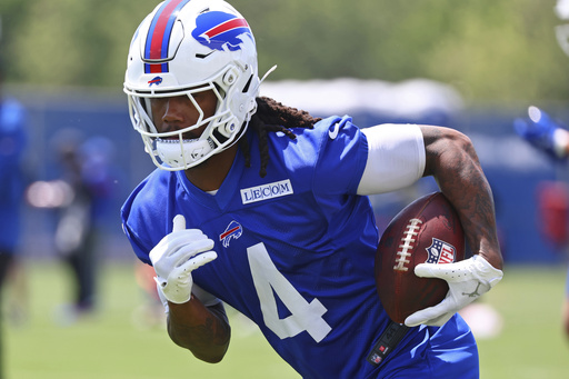 Buffalo Bills running back James Cook (4) runs a drill during practice at NFL football minicamp in Orchard Park, N.Y., Tuesday June 10, 2025. (AP Photo/Jeffrey T. Barnes)