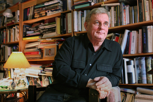 FILE - Author Edmund White appears in his New York apartment on April 24, 2006. (AP Photo/Mark Lennihan, File)