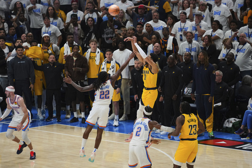 CORRECTS TO GAME WINNING BASKET, NOT 3-PT BASKET - Indiana Pacers guard Tyrese Haliburton (0) shoots the game winning basket over Oklahoma City Thunder guard Cason Wallace (22) in the closing second of the second half of Game 1 of the NBA Finals basketball series Thursday, June 5, 2025, in Oklahoma City. (AP Photo/Nate Billings)