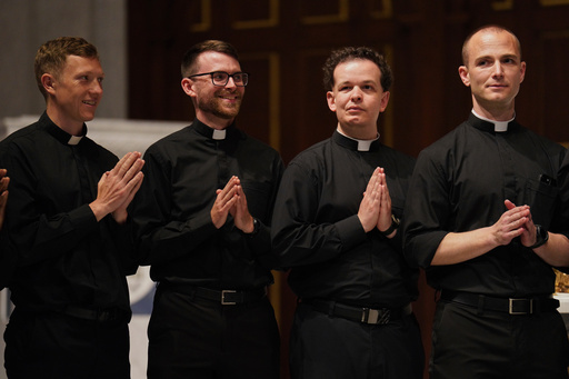 CORRECTS TO JOSEPH, NOT JOESPH - From left, the Rev. Joseph Connor, the Rev. Tim Banach, the Rev. John Meyerhofer, and the Rev. Mike Sampson, attend rehearsal for their ordination Mass at the Cathedral of Saint Thomas More in Arlington, Va., on Friday, June 6, 2025. (AP Photo/Jessie Wardarski)