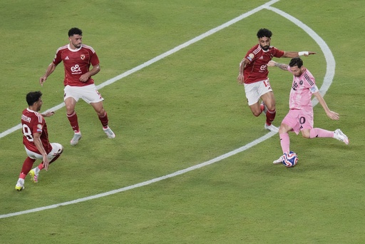 Inter Miami's Lionel Messi, right, attempts a shot on goal during the Club World Cup group A soccer match between Al Ahly and Inter Miami in Miami, Fla., Saturday, June 14, 2025. (AP Photo/John Raoux)