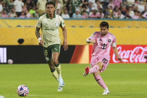 Inter Miami's Lionel Messi shoots on goal against Palmeiras' Richard Rios during the Club World Cup Group A soccer match between Inter Miami and Palmeiras in Miami Gardens, Fla., Monday, June 23, 2025. (AP Photo/Lynne Sladky)