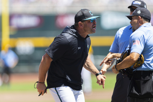 Coastal Carolina head coach Kevin Schnall, left, screams at the umpires after being ejected in the first inning against LSU in Game 2 of the NCAA College World Series baseball finals in Omaha, Neb., Sunday, June 22, 2025. (AP Photo/Rebecca S. Gratz)