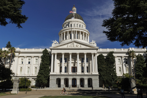 FILE - People walk around the California State Capitol, Aug. 5, 2024, in Sacramento, Calif. (AP Photo/Juliana Yamada, File)