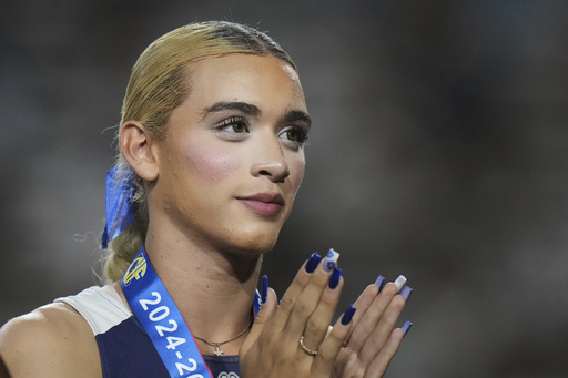 FILE - AB Hernandez, a transgender student at Jurupa Valley High School, stands on the podium during a medal ceremony for the triple jump at the California high school track-and-field championships in Clovis, Calif., May 31, 2025. (AP Photo/Jae C. Hong, file)