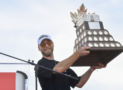 Florida Panthers' Sam Bennett holds up the Conn Smythe Trophy during the NHL hockey team's Stanley Cup championship celebration, Sunday, June 22, 2025, in Fort Lauderdale, Fla. (AP Photo/Michael Laughlin)
