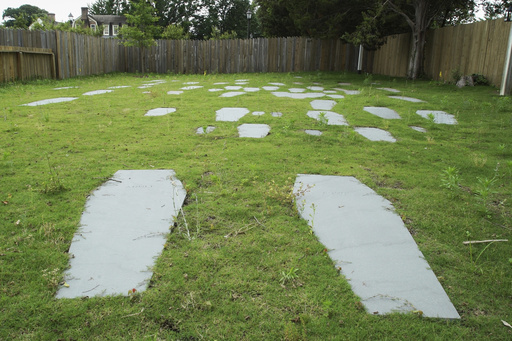 Casket-shaped stones mark the 62 graves identified at the original site of the First Baptist Church of Williamsburg in Williamsburg, Va., on May 30, 2025. (AP Photo/Allen G. Breed)