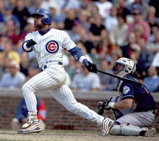 FILE - Chicago Cubs' Sammy Sosa (21) and San Diego Padres catcher Phil Nevin watch Sosa's game-winning three-run homer with one out in the ninth on June 2, 1999 in Chicago. (AP Photo/Stephen J. Carrera, File)