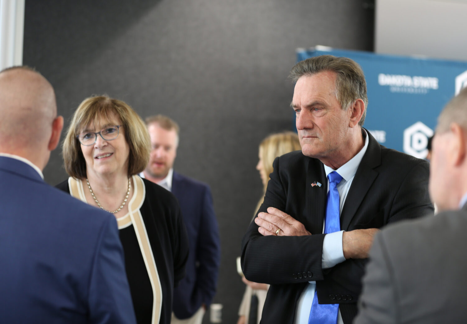 Dakota State University President José-Marie Griffiths, left, and South Dakota Gov. Larry Rhoden speak with attendees at a press conference on May 23, 2025, in Madison. (John Hult/South Dakota Searchlight)