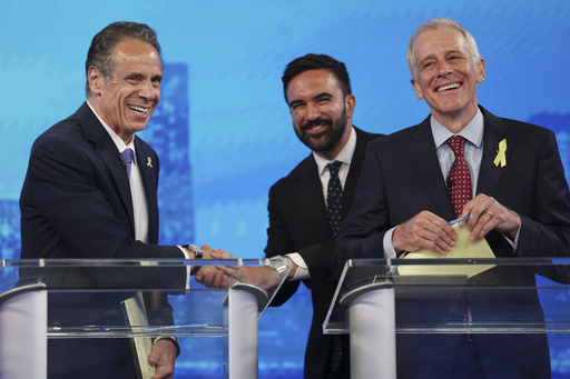 Democratic mayoral candidates Andrew Cuomo, left, shakes hands with Zohran Mamdani, center, as Whitney Tilson reacts after participating in a Democratic mayoral primary debate, Wednesday, June 4, 2025, in New York. (AP Photo/Yuki Iwamura, Pool)