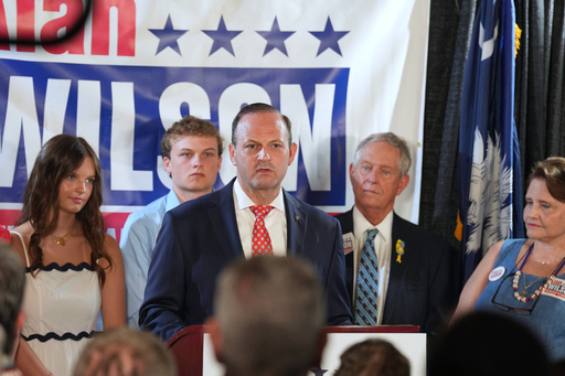 South Carolina Attorney General Alan Wilson, center, speaks at his launch event for the state's 2026 governor's race as his father, Rep. Joe Wilson, R-S.C., watches, Monday, June 23, 2025, in Lexington, S.C. (AP Photo/Meg Kinnard)