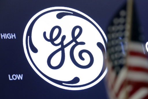 FILE - In this June 26, 2018, file photo the General Electric logo appears above a trading post on the floor of the New York Stock Exchange. (AP Photo/Richard Drew, File)
