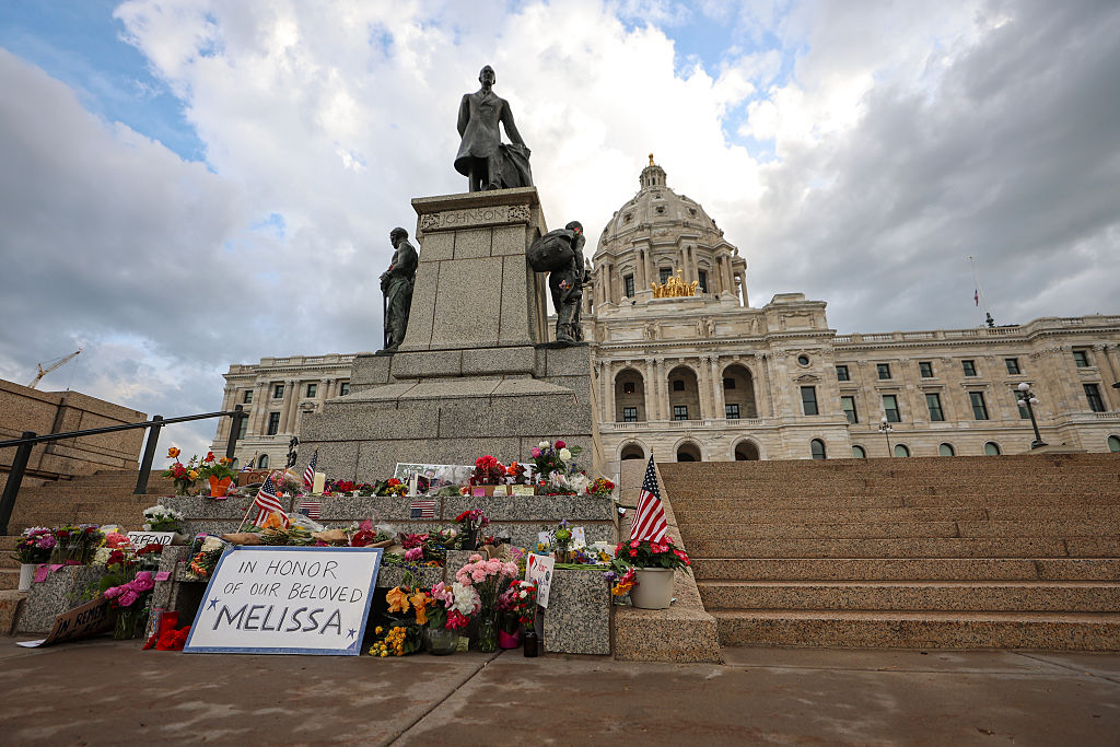 Flowers, notes and American flags adorn a makeshift memorial for Minnesota state Rep. Melissa Hortman and her husband, Mark, at the Minnesota State Capitol. In the wake of the assassination, more public officials across the country are taking stock of their safety. (Steven Garcia/Getty Images)