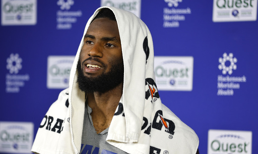 New York Giants linebacker Brian Burns talks to reporters after NFL football practice in East Rutherford, N.J., Thursday, June 5, 2025. (AP Photo/Noah K. Murray)