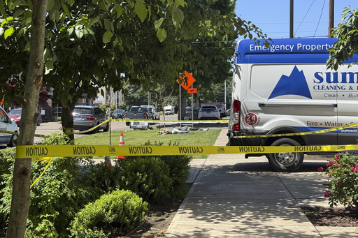 Police tape cordons off an area outside the Union Gospel Mission homeless shelter in Salem, Ore., Monday, June 2, 2025. (AP Photo/Claire Rush)