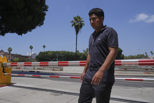 Alejandro Barranco arrives at the Metropolitan Detention Center to check on his father Narciso, who was recently detained by federal agents, on Monday, June 23, 2025, in Los Angeles. (AP Photo/Damian Dovarganes)