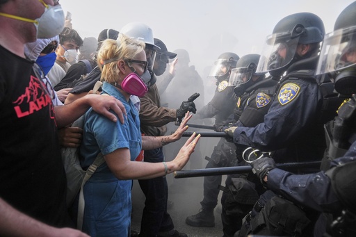 FILE - Protesters confront police on the 101 Freeway near the Metropolitan Detention Center in downtown Los Angeles, Sunday, June 8, 2025, following last night's immigration raid protest. (AP Photo/Jae C. Hong, File)