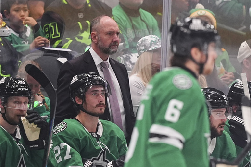 Dallas Stars head coach Pete DeBoer, center, watches play against the Winnipeg Jets in the second period of Game 3 of a second-round NHL hockey playoff series in Dallas, Sunday, May 11, 2025. (AP Photo/Julio Cortez)
