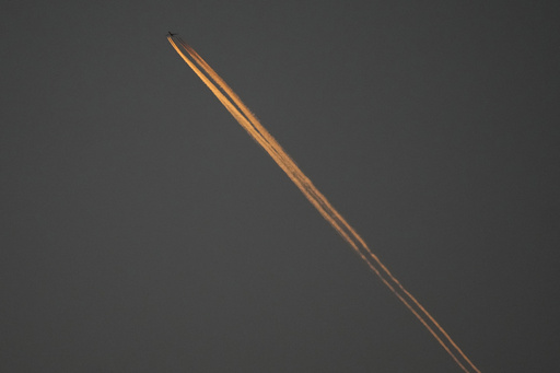 FILE - A plane flies over Oakland Alameda Coliseum in Oakland, Calif., April 30, 2024. (AP Photo/Jeff Chiu, File)