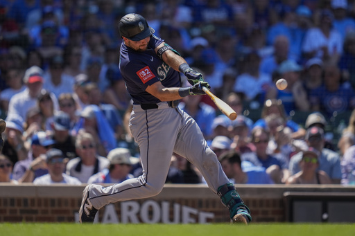 Seattle Mariners' Cal Raleigh hits a two-run home run during the seventh inning of a baseball game against the Chicago Cubs, Friday, June 20, 2025, in Chicago. (AP Photo/Erin Hooley)