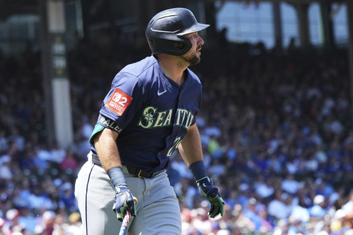 Seattle Mariners' Cal Raleigh watches his two-run home run during the first inning of a baseball game against the Chicago Cubs in Chicago, Sunday, June 22, 2025. (AP Photo/Nam Y. Huh)