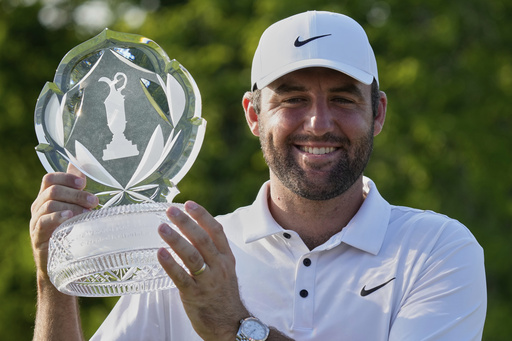Scottie Scheffler holds the trophy after winning the Memorial golf tournament Sunday, June 1, 2025, in Dublin, Ohio. (AP Photo/Sue Ogrocki)