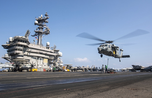FILE - This photograph released by the U.S. Navy shows a MH-60S Sea Hawk helicopter hovering over the USS Carl Vinson aircraft carrier while operating in the Middle East April 12, 2025. (Petty Officer 3rd Class Nathan Jordan/U.S. Navy via AP, File)