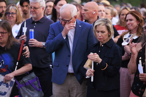 Minnesota Gov. Tim Walz and his wife Gwen Walz attend a candlelight vigil for former House Speaker Melissa Hortman and her husband Mark, who were fatally shot, at the state Capitol, Wednesday, June 18, 2025, in St. Paul, Minn. (AP Photo/Nikolas Liepins)