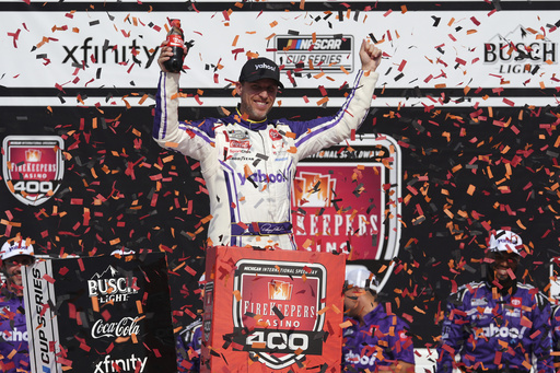Denny Hamlin celebrates his victory in a NASCAR Cup Series auto race at Michigan International Speedway in Brooklyn, Mich., Sunday, June 8, 2025. (AP Photo/Paul Sancya)