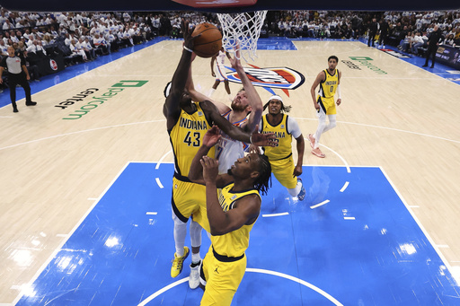 Oklahoma City Thunder forward Chet Holmgren (7), Indiana Pacers forward Pascal Siakam (43) and forward Aaron Nesmith (23) reach for the ball during Game 1 of the NBA Finals basketball series Thursday, June 5, 2025, in Oklahoma City. (Matthew Stockman/Pool Photo via AP)