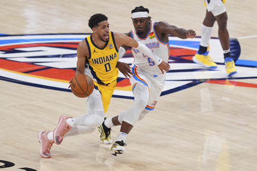 Indiana Pacers guard Tyrese Haliburton (0) drives past Oklahoma City Thunder guard Luguentz Dort (5) during the second half of Game 5 of the NBA Finals basketball series, Monday, June 16, 2025, in Oklahoma City. (AP Photo/Kyle Phillips)