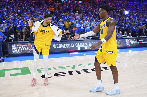 Indiana Pacers guard Tyrese Haliburton (0) greets guard Bennedict Mathurin (00) after losing Game 2 of the NBA Finals basketball series against the Oklahoma City Thunder Sunday, June 8, 2025, in Oklahoma City. (AP Photo/Julio Cortez)