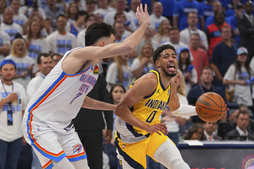 Indiana Pacers guard Tyrese Haliburton (0) drives past Oklahoma City Thunder forward Chet Holmgren (7) during the second half of Game 5 of the NBA Finals basketball series, Monday, June 16, 2025, in Oklahoma City. (AP Photo/Kyle Phillips)