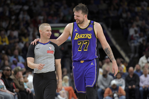 FILE - Los Angeles Lakers guard Luka Doncic (77) talks with referee Tyler Ford in the second half of an NBA basketball game against Memphis Grizzlies Saturday, March 29, 2025, in Memphis, Tenn. (AP Photo/Brandon Dill,File)