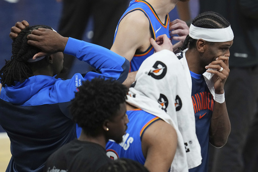 Oklahoma City Thunder guard Shai Gilgeous-Alexander, right, stands with teammates during a timeout during the second half of Game 6 of the NBA Finals basketball series against the Indiana Pacers, Thursday, June 19, 2025, in Indianapolis. (AP Photo/Michael Conroy)