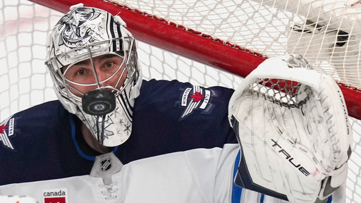 FILE - Winnipeg Jets goaltender Connor Hellebuyck watches the puck on a save against the Boston Bruins during the third period of an NHL hockey game Jan. 30, 2025, in Boston. (AP Photo/Charles Krupa, File)