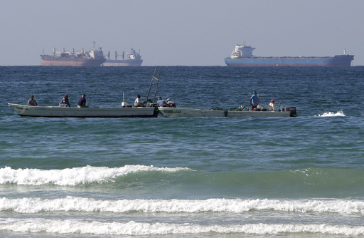 FILE - In this Jan. 19, 2012 file photo, fishing boats are seen in front of oil tankers south of the Strait of Hormuz, offshore the town of Ras Al Khaimah in United Arab Emirates. (AP Photo/Kamran Jebreili, File)