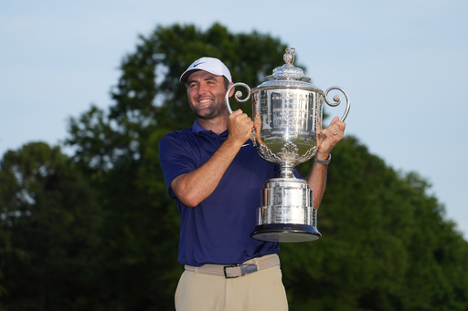 Scottie Scheffler holds the Wanamaker trophy after winning the PGA Championship golf tournament at the Quail Hollow Club, Sunday, May 18, 2025, in Charlotte, N.C. (AP Photo/Matt York)