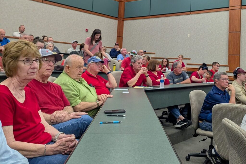 A crowd listens to a presentation on June 17, 2025, at Mitchell Technical College about the possibility of constructing a state prison near Mitchell. (John Hult/South Dakota Searchlight)