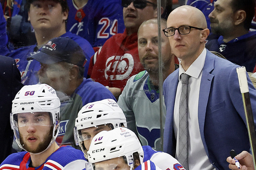 New York Rangers assistant coach Dan Muse, right, watches during the third period in Game 4 of an NHL hockey Stanley Cup second-round playoff series in Raleigh, N.C., Saturday, May 11, 2024. (AP Photo/Karl B DeBlaker File)