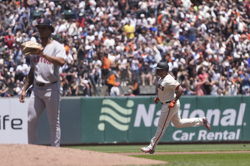 San Francisco Giants' Rafael Devers, middle right, circles the bases after hitting a two-run home run off of Boston Red Sox pitcher Brayan Bello, left, during the third inning of a baseball game in San Francisco, Saturday, June 21, 2025. (AP Photo/Jeff Chiu)