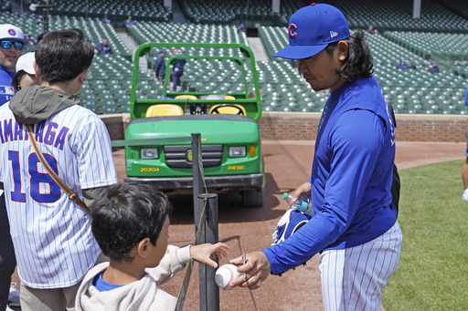 Chicago Cubs pitcher Shota Imanaga signs autographs before a baseball game against the Colorado Rockies Monday, May 26, 2025, in Chicago. (AP Photo/David Banks)