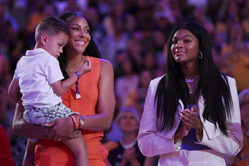 Former Los Angeles Sparks player Candace Parker, second from left, reacts with her family during her jersey retirement ceremony during a WNBA basketball game between the Sparks and the Chicago Sky, Sunday, June 29, 2025, in Los Angeles. (AP Photo/Jessie Alcheh)